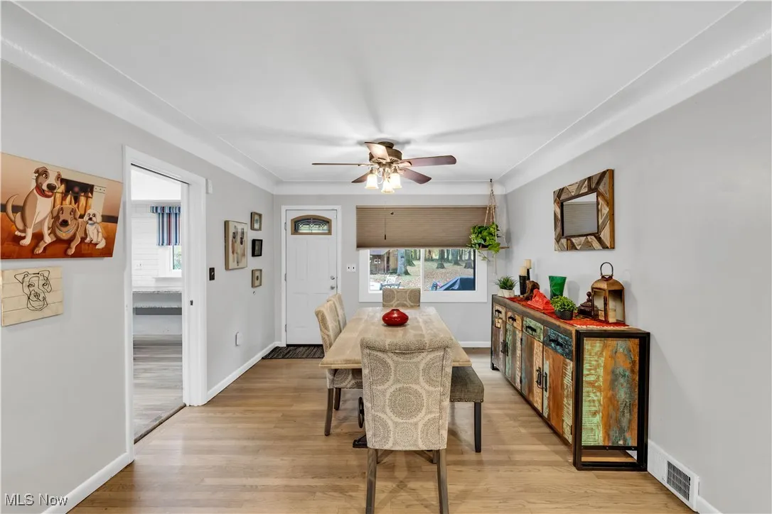 Dining area with light wood-type flooring and ceiling fan
