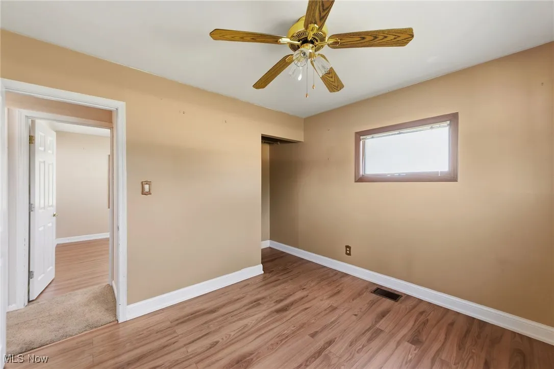 Unfurnished bedroom featuring light wood-type flooring and a ceiling fan
