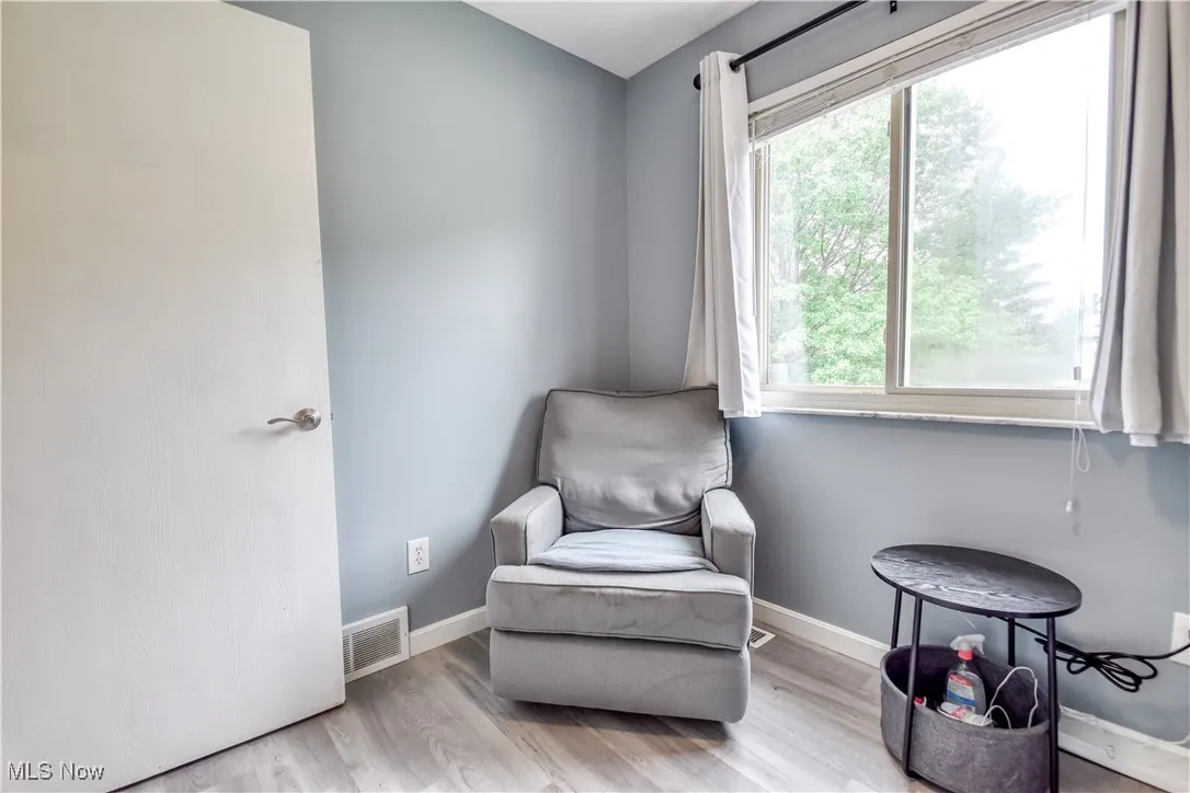 Living area with baseboards and wood finished floors