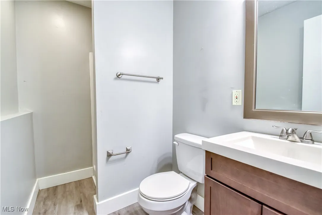 Half bath featuring vanity and light wood-style flooring