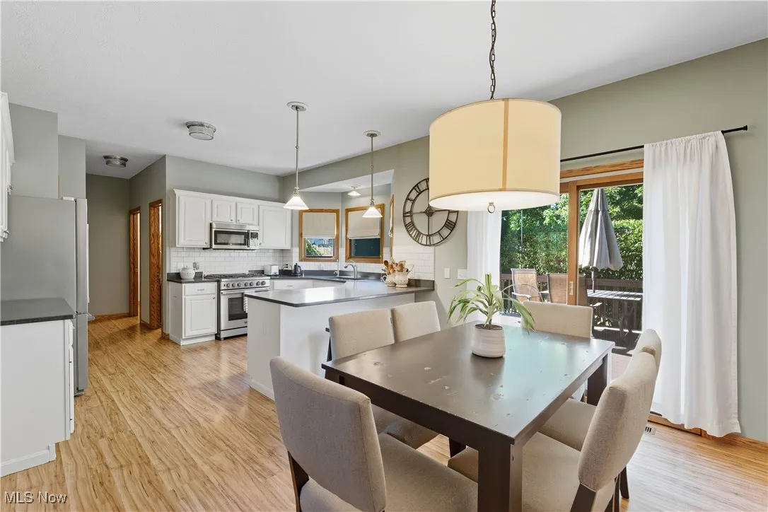 Dining area with light wood-style floors
