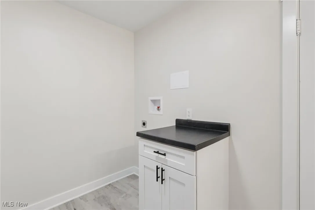 Laundry area with cabinet space, hookup for a washing machine, and electric dryer hookup
