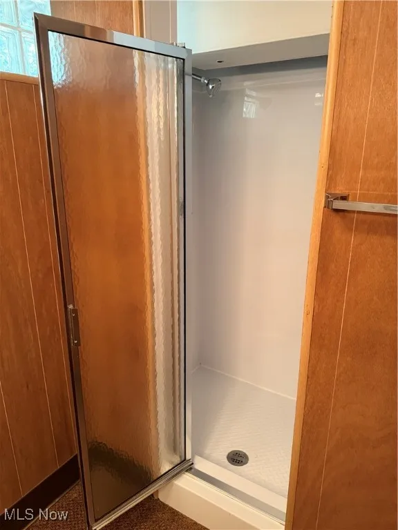Full bath featuring a shower stall