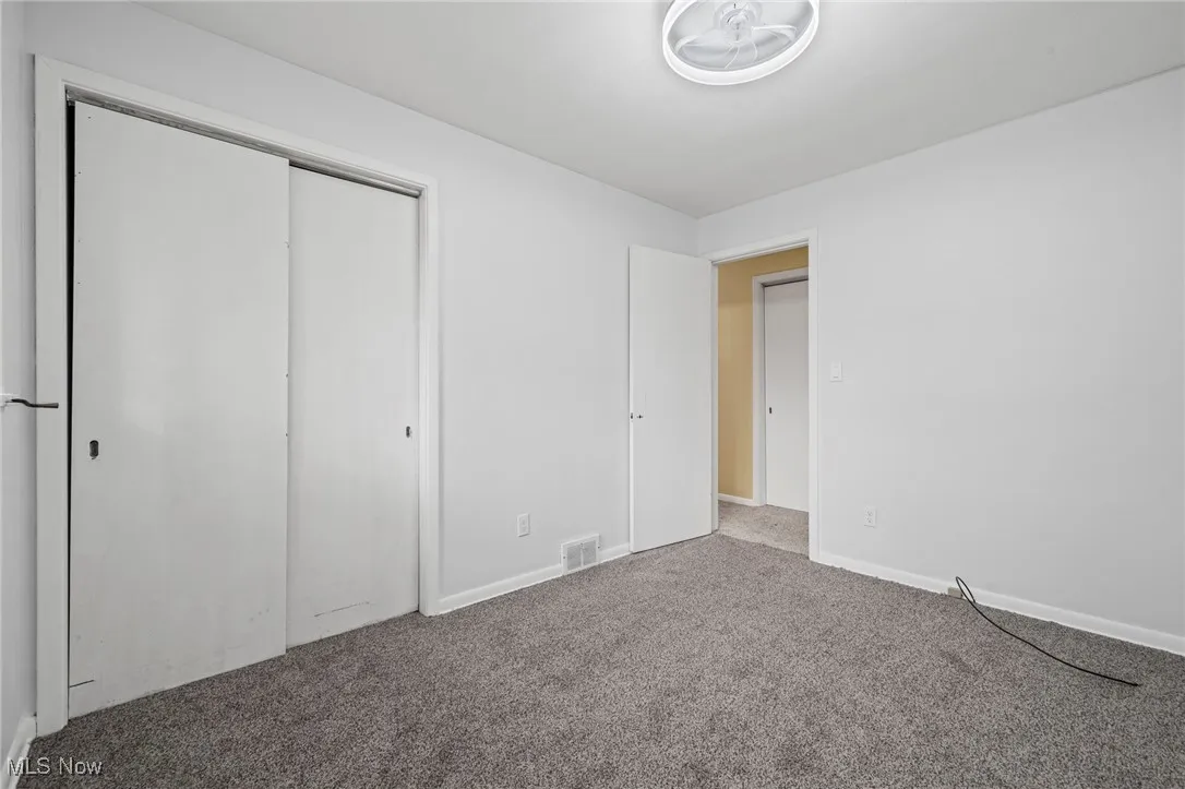 Unfurnished bedroom featuring carpet floors and a closet