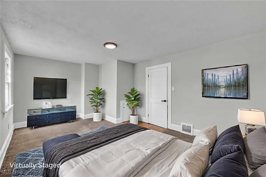 Bedroom featuring carpet and baseboards