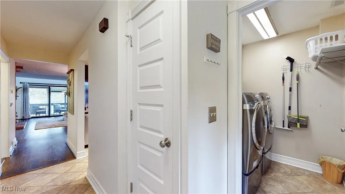 Laundry area with baseboards and separate washer and dryer