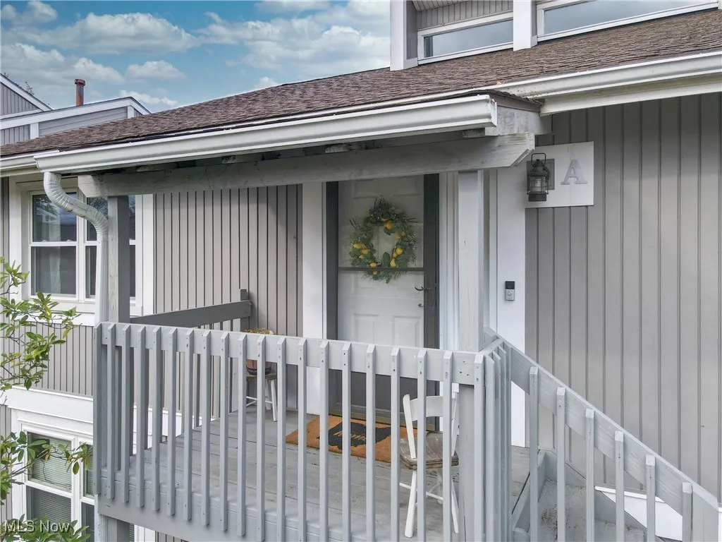 Entrance to property featuring roof with shingles