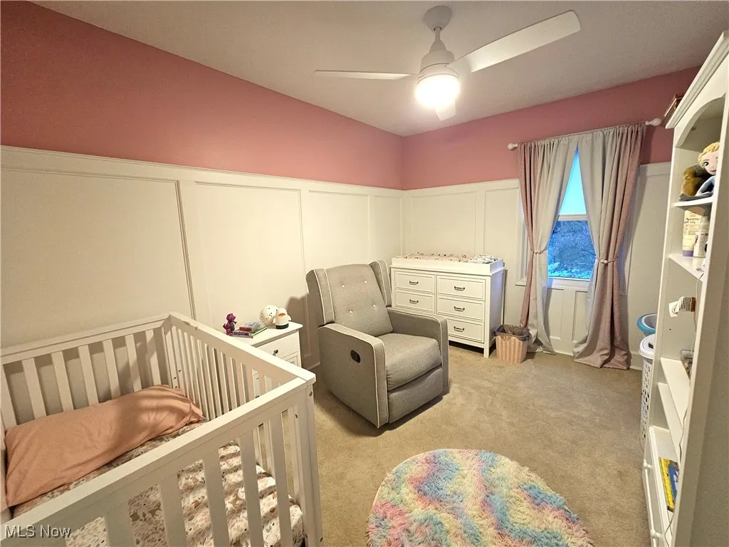 Bedroom with a wainscoted wall