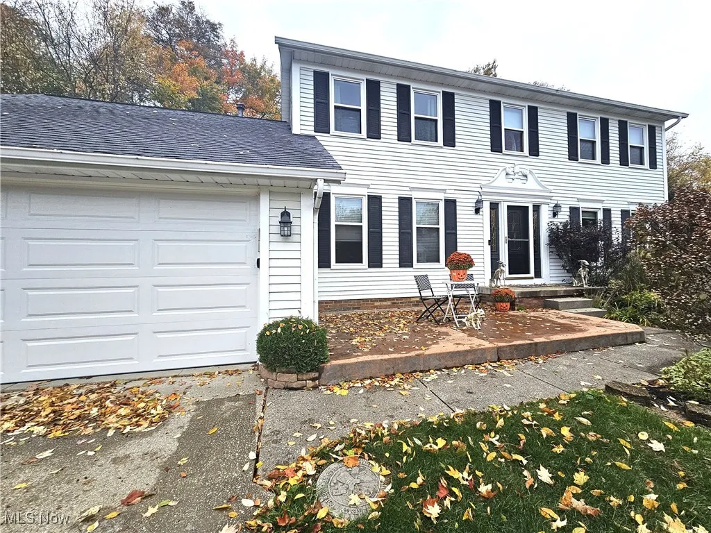 Colonial home featuring attached garage