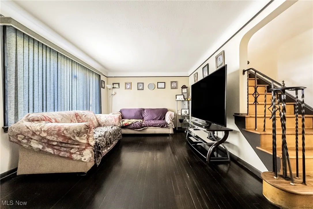 Living area with wood finished floors and baseboards