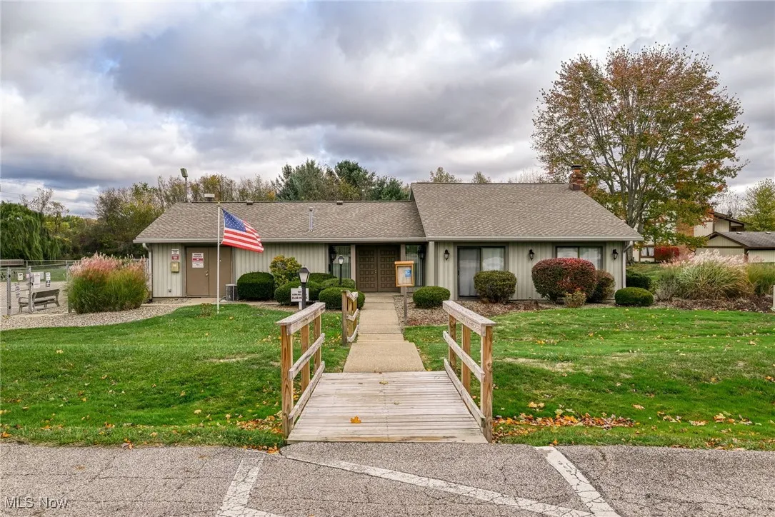 Ranch-style home with a front yard, a chimney, and a shingled roof