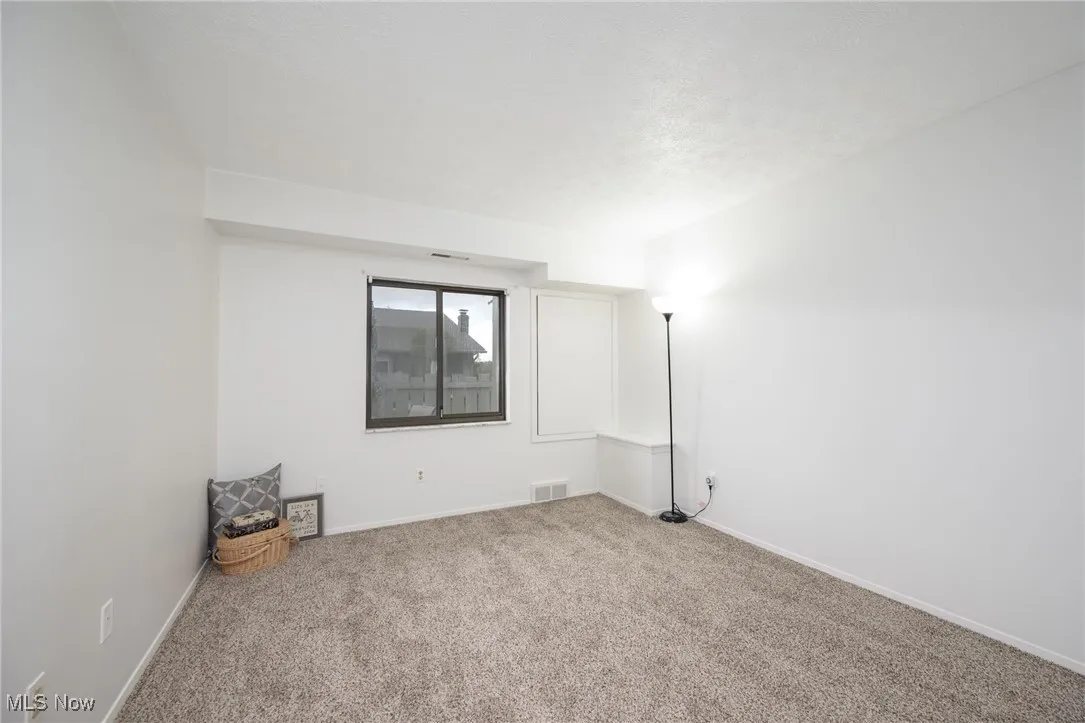 Unfurnished room featuring carpet floors and a textured ceiling