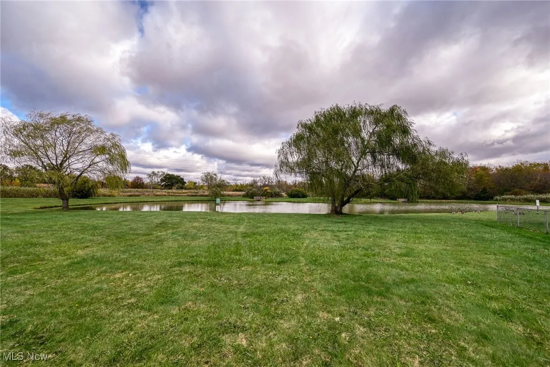 View of grassy yard with a water view