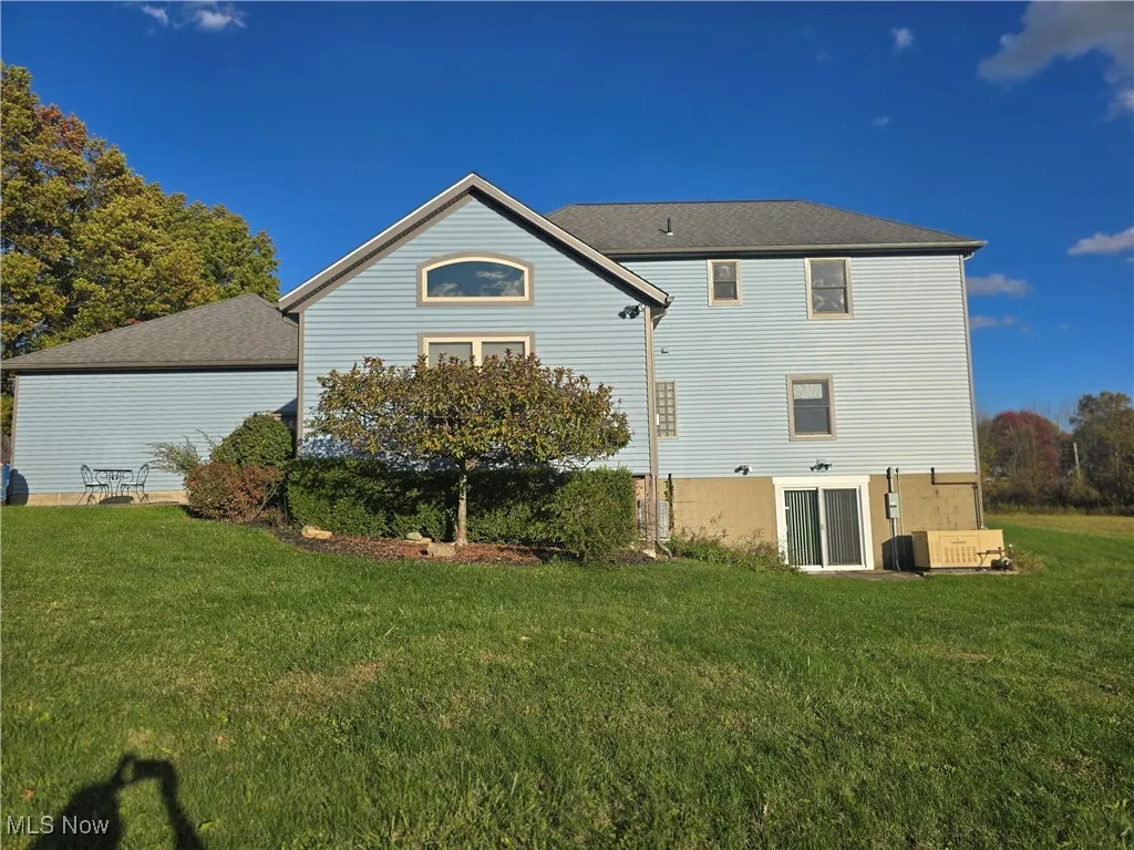 Rear view of property with a walk out basement