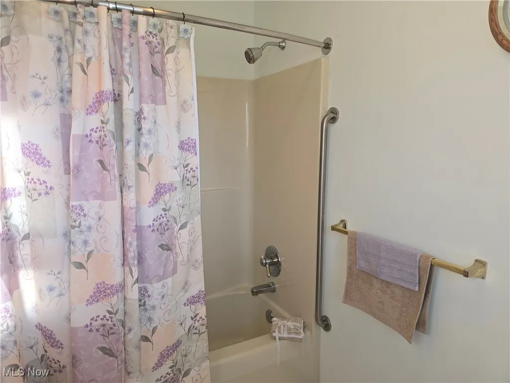 Second floor bathroom with shower / bathtub combination.