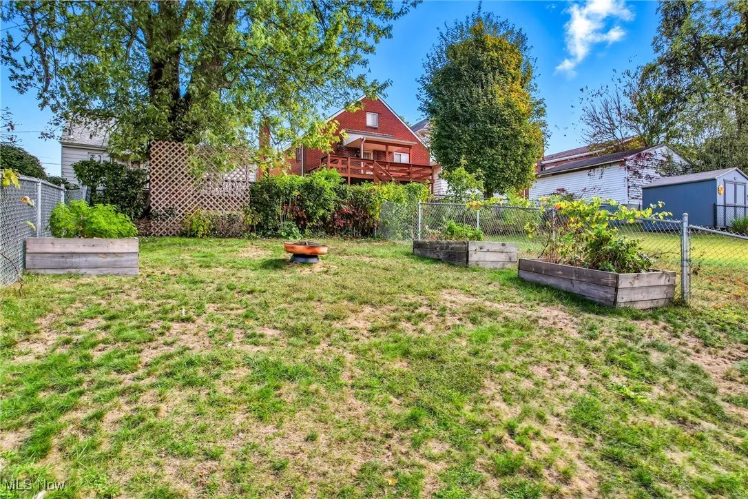 Fenced yard with raised garden beds