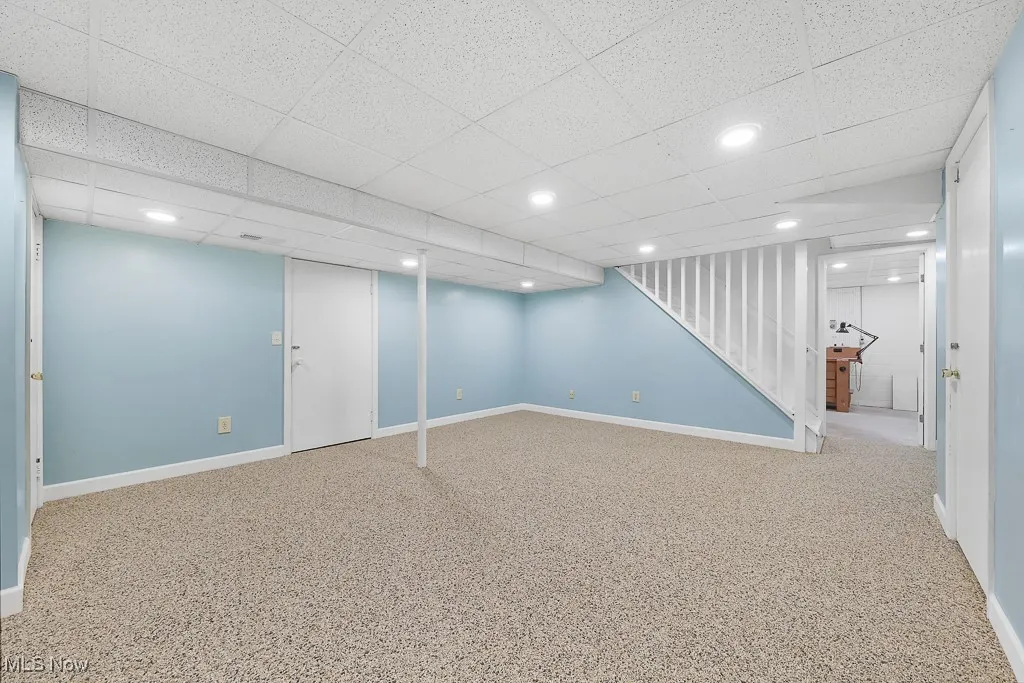 Finished basement featuring a drop ceiling and recessed lighting