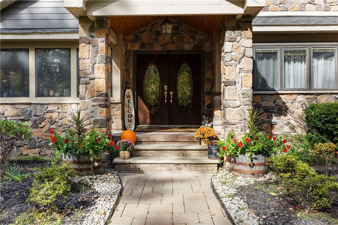 View of exterior entry with stone siding