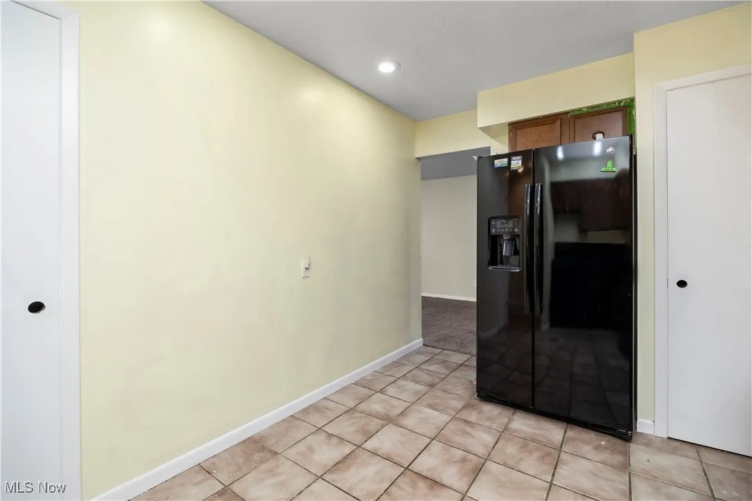 Unfurnished room featuring light tile patterned floors and recessed lighting