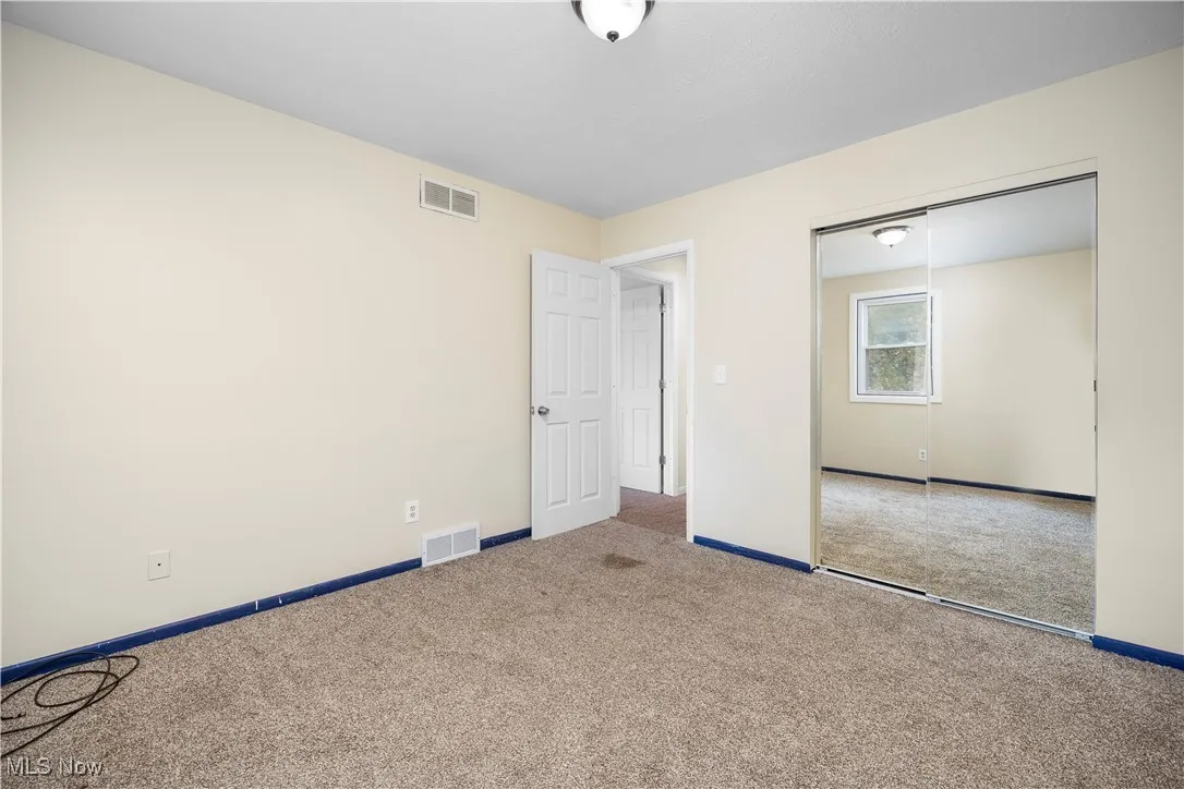 Unfurnished bedroom with a closet and carpet