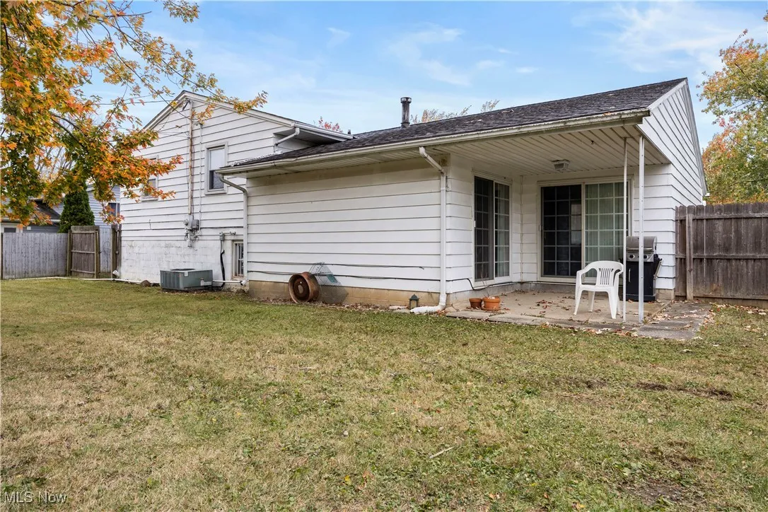Back of property featuring a patio and roof with shingles