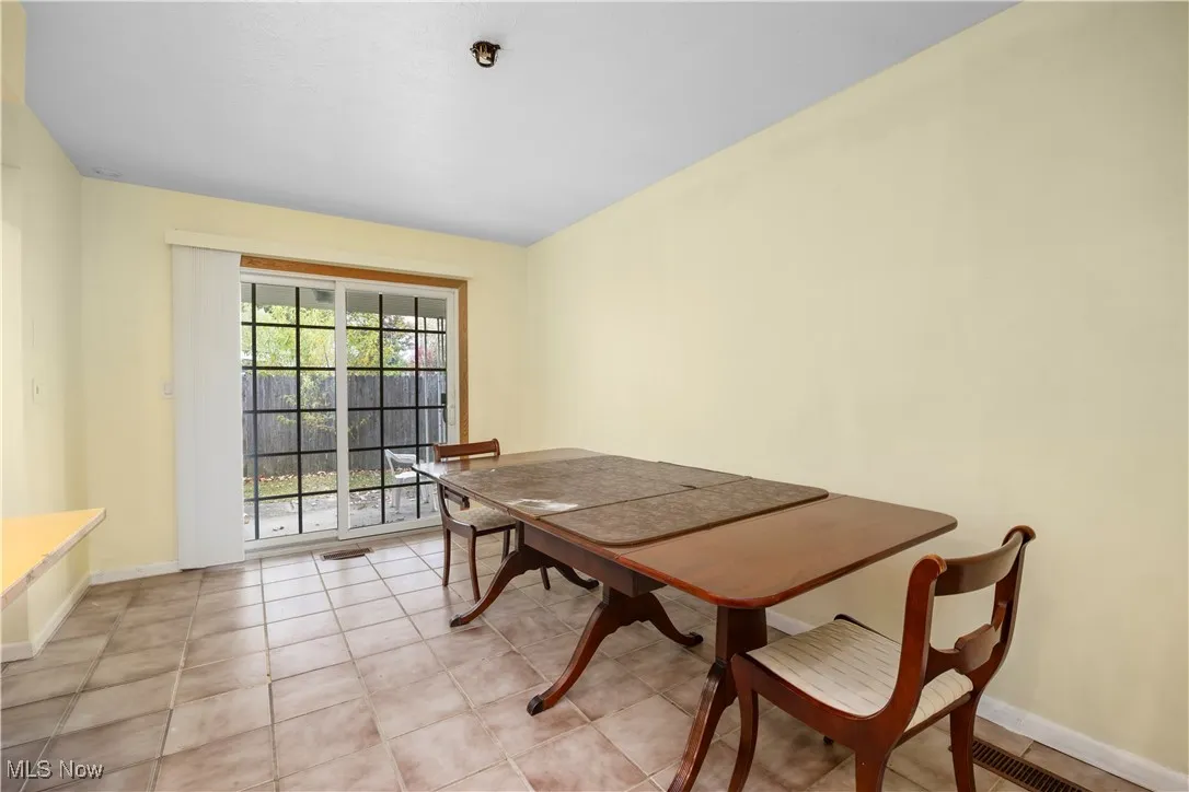 Dining area with light tile patterned floors