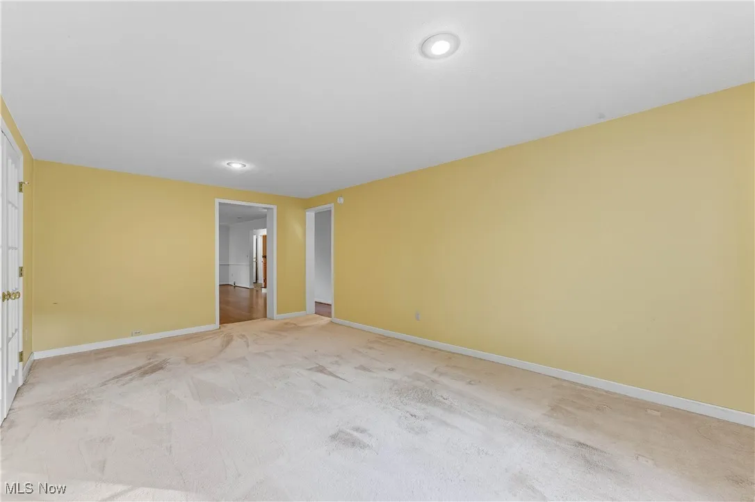 Spare room featuring light colored carpet and recessed lighting