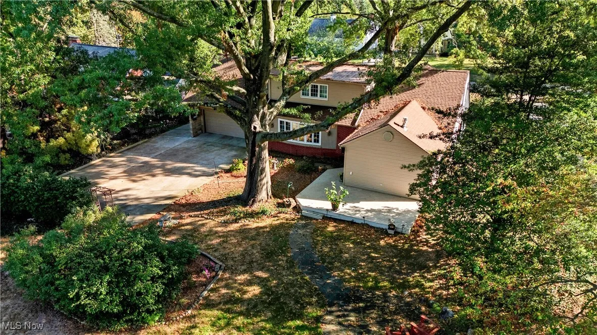 View of yard with concrete driveway and a garage