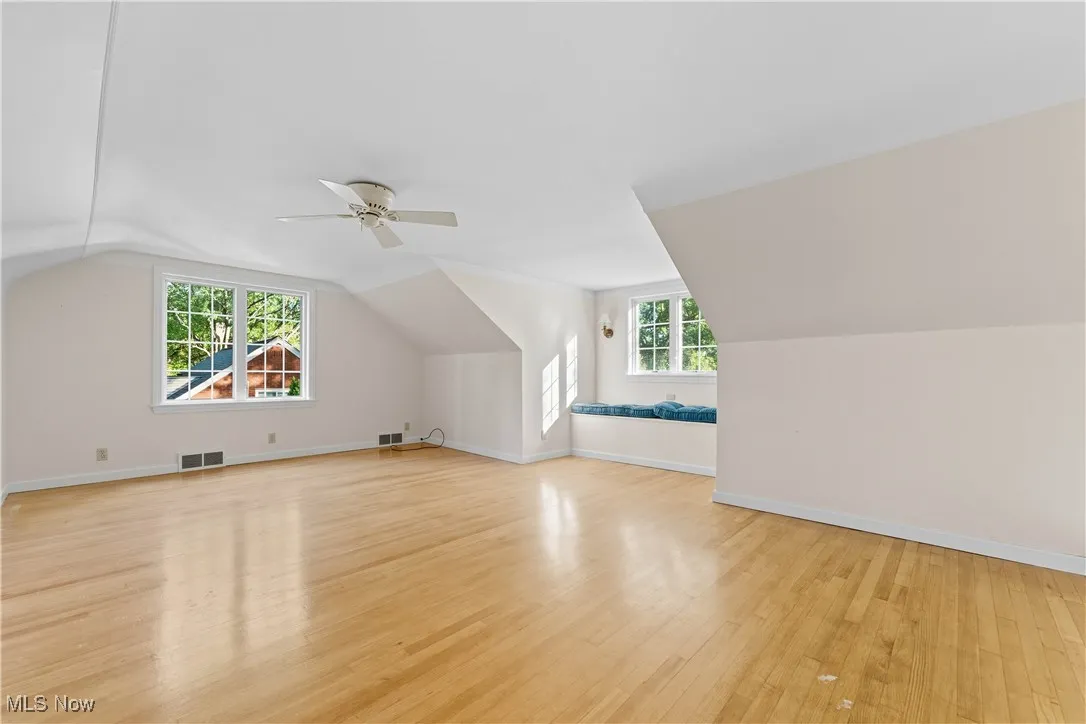 Bonus room featuring lofted ceiling and light wood-type flooring