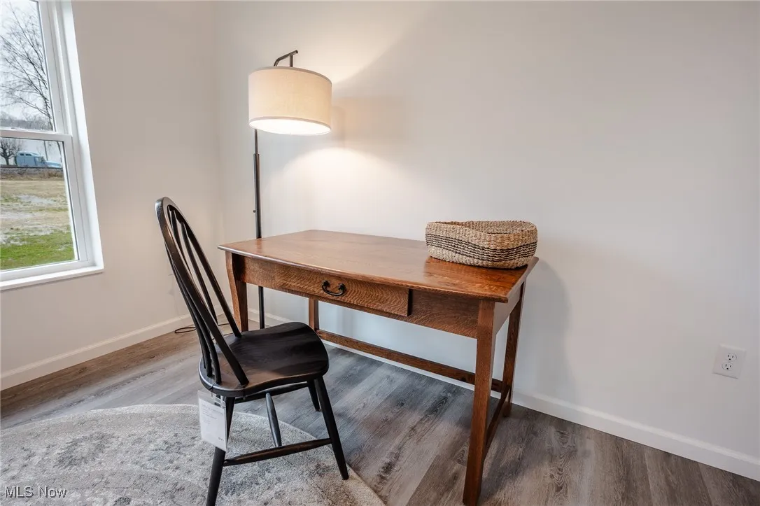 Office featuring wood finished floors and baseboards