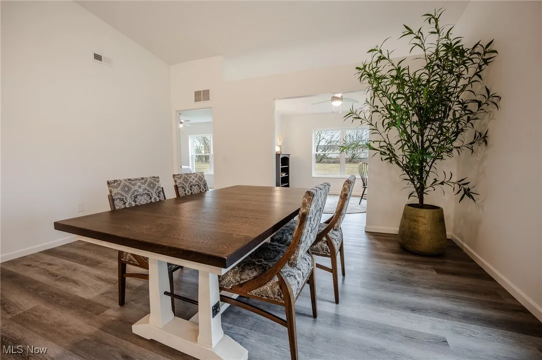 Dining space featuring wood finished floors and baseboards