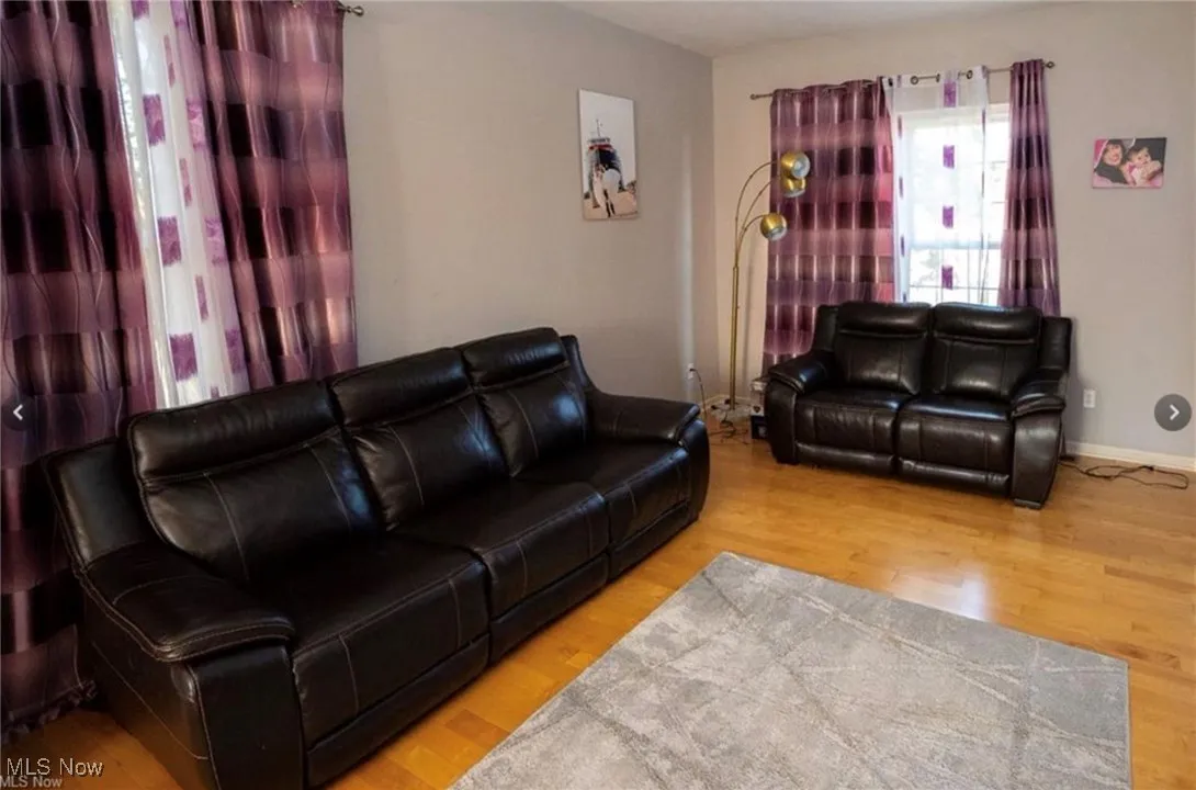 Living area with wood finished floors and baseboards