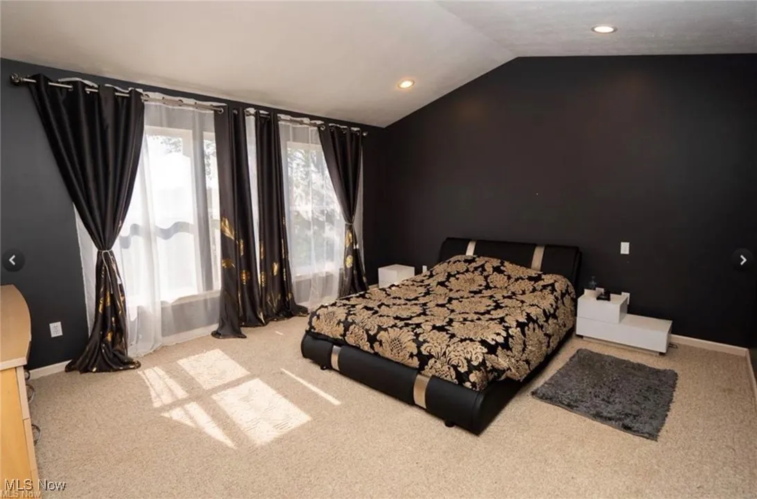Bedroom with lofted ceiling, carpet, and recessed lighting