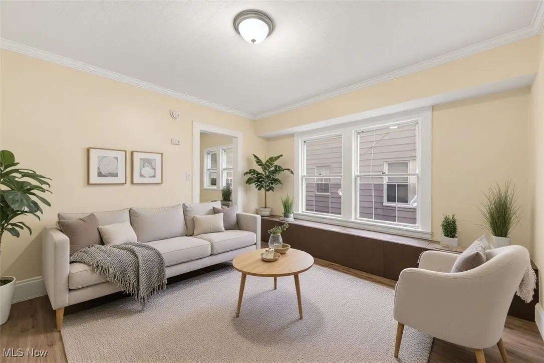 Living room featuring wood finished floors and ornamental molding