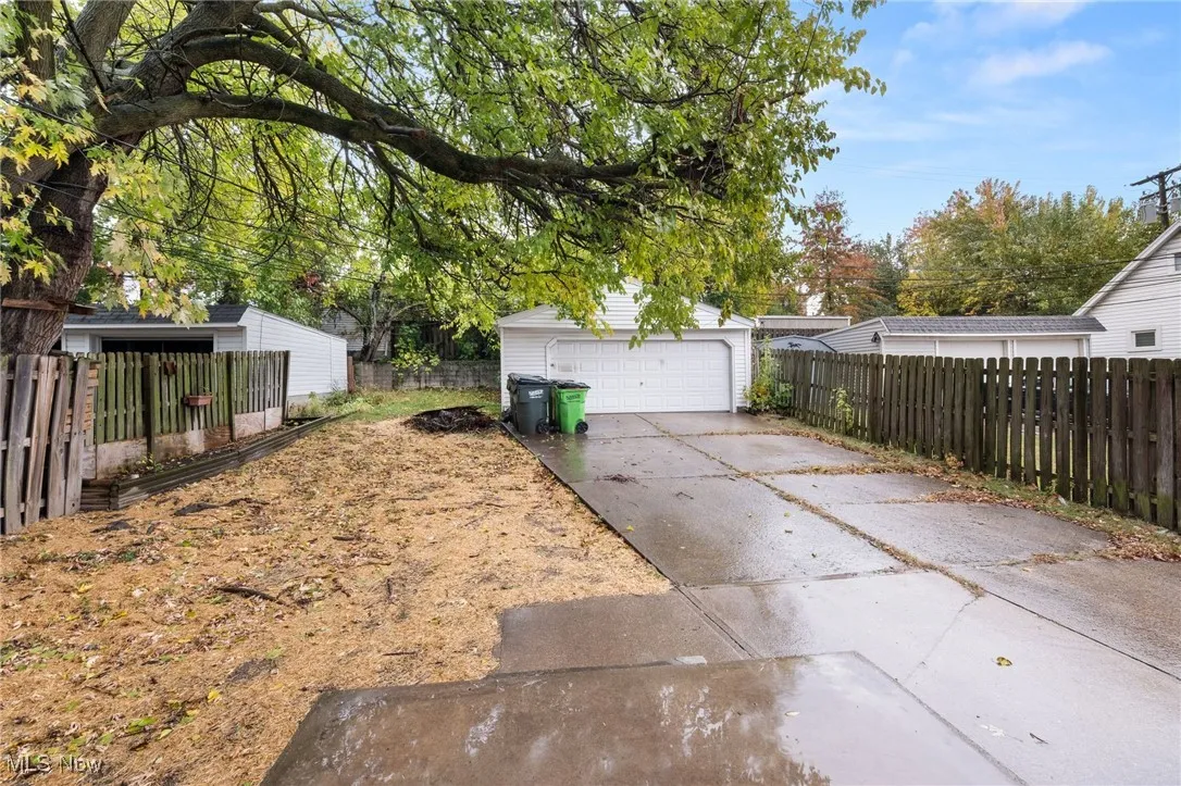View of yard with an outdoor structure and a detached garage