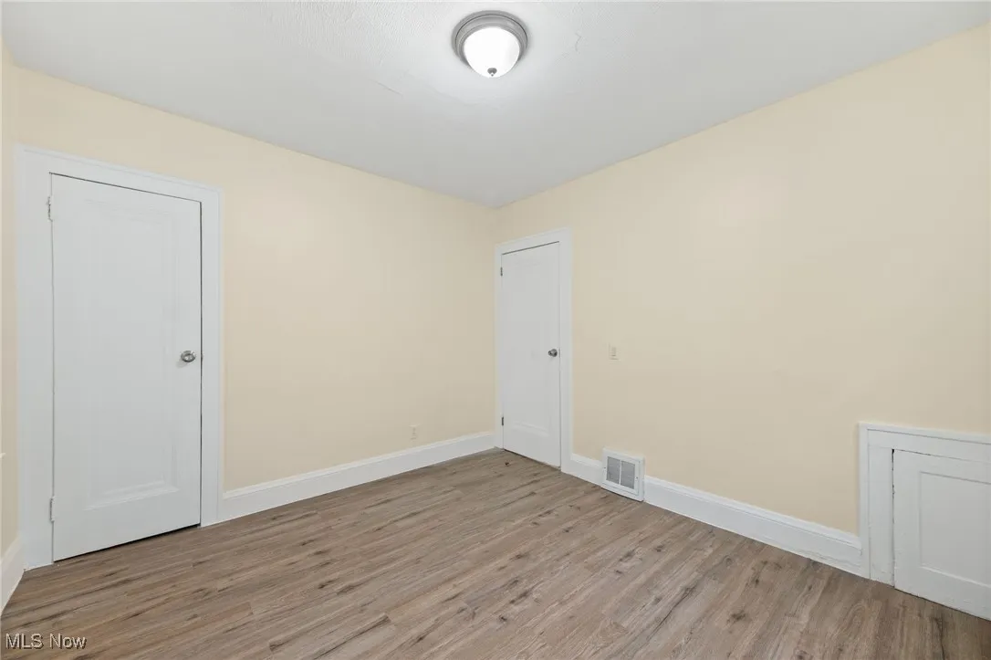 Spare room featuring wood finished floors and baseboards