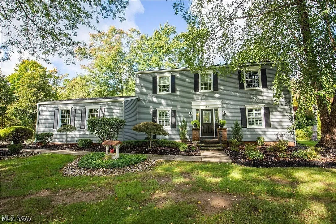 Colonial inspired home featuring a front lawn