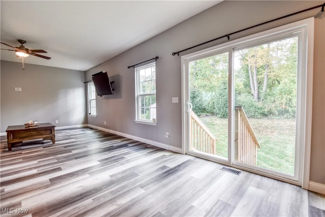 Unfurnished living room featuring light wood-style floors and ceiling fan