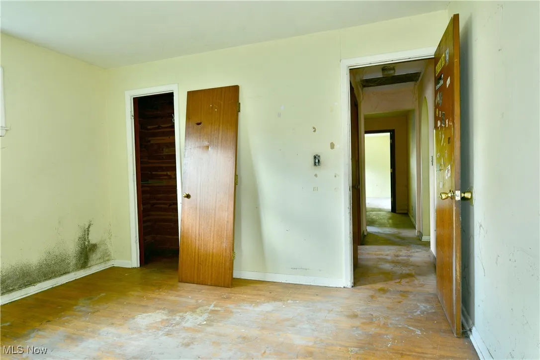 Unfurnished bedroom with wood-type flooring