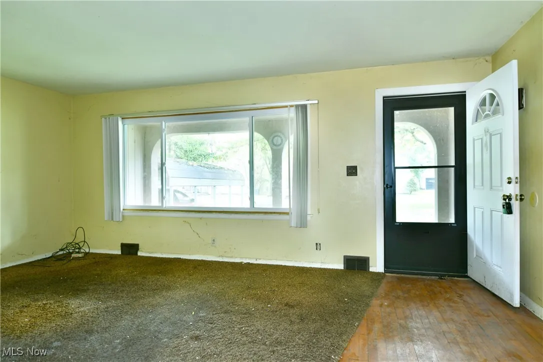 Foyer entrance with hardwood / wood-style floors and baseboards