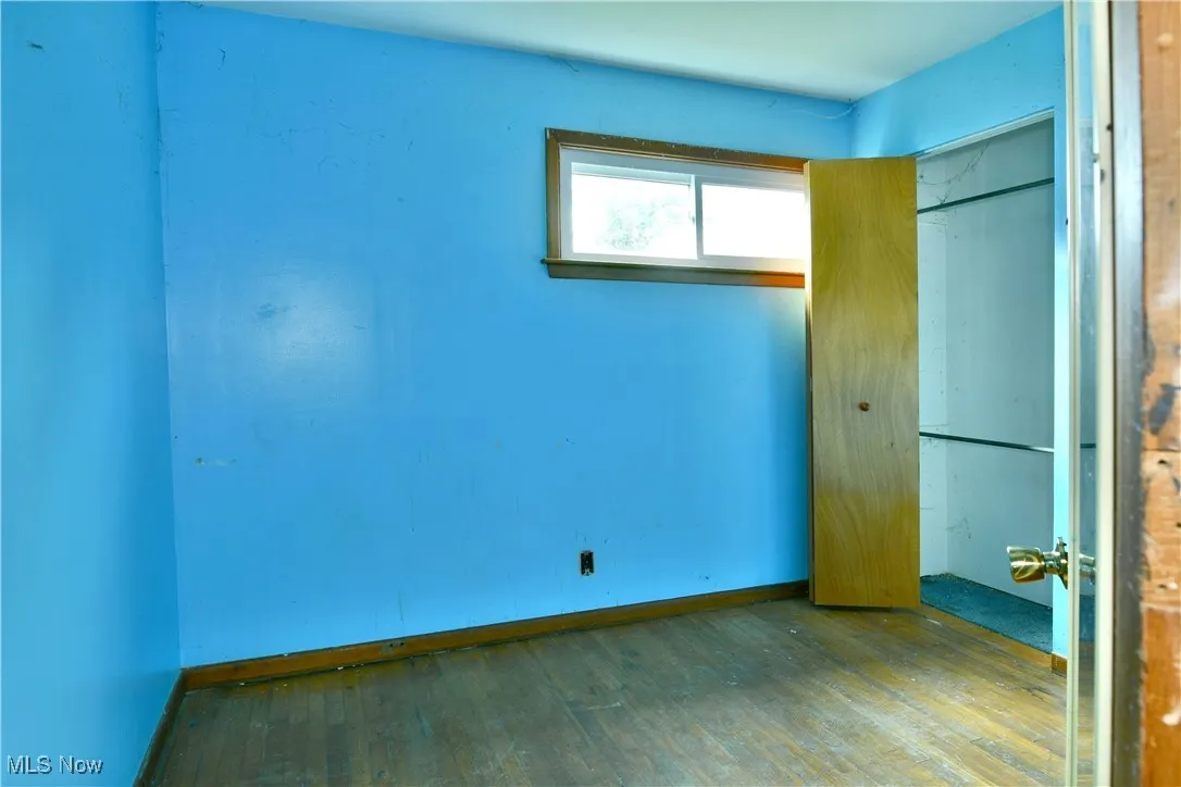 Unfurnished bedroom featuring wood-type flooring and a closet