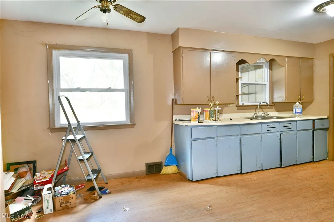 Bathroom featuring vanity, light wood-type flooring, and ceiling fan