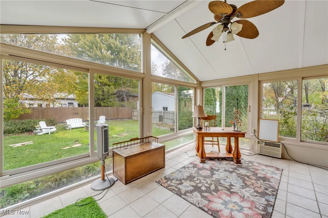Sunroom featuring ceiling fan