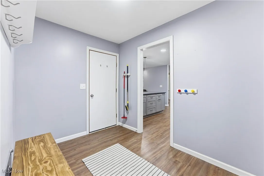 Foyer with wood finished floors and baseboards