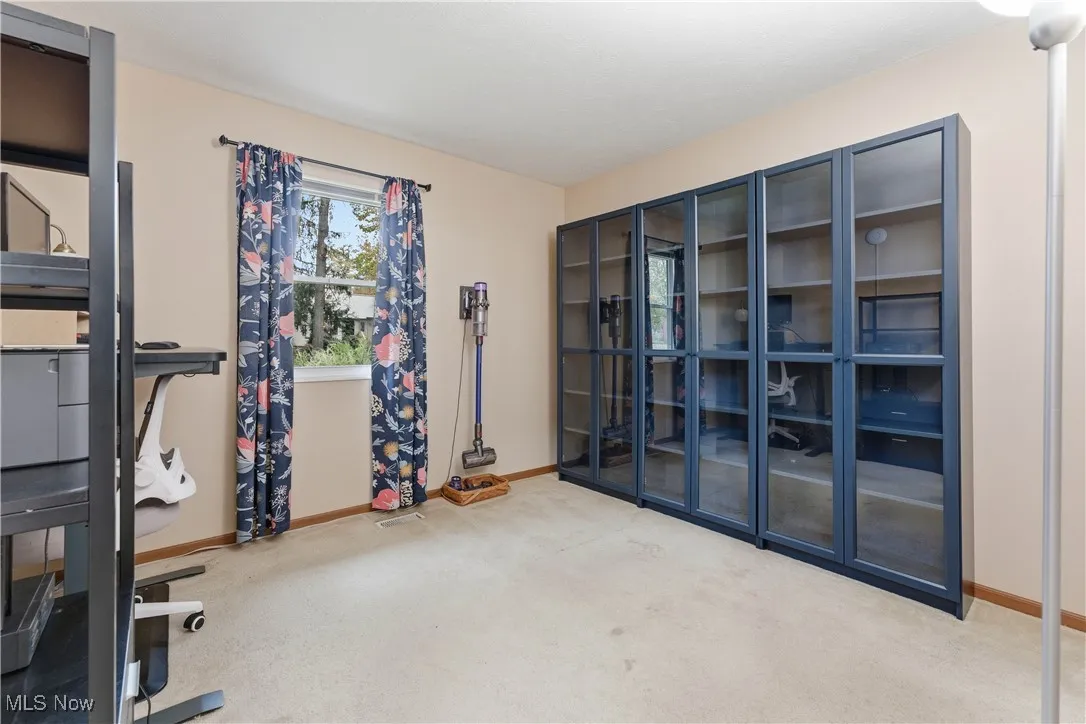 Exercise area featuring carpet floors and baseboards