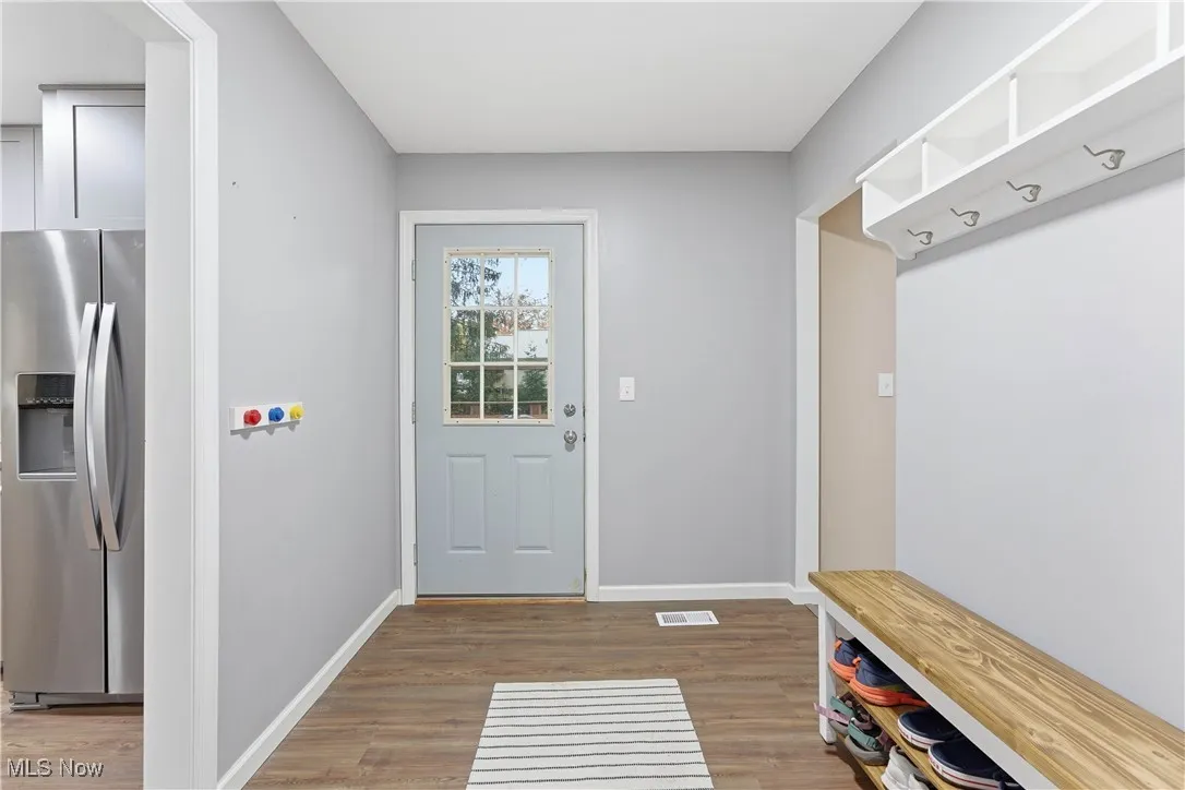 Mudroom with baseboards and dark wood-style flooring