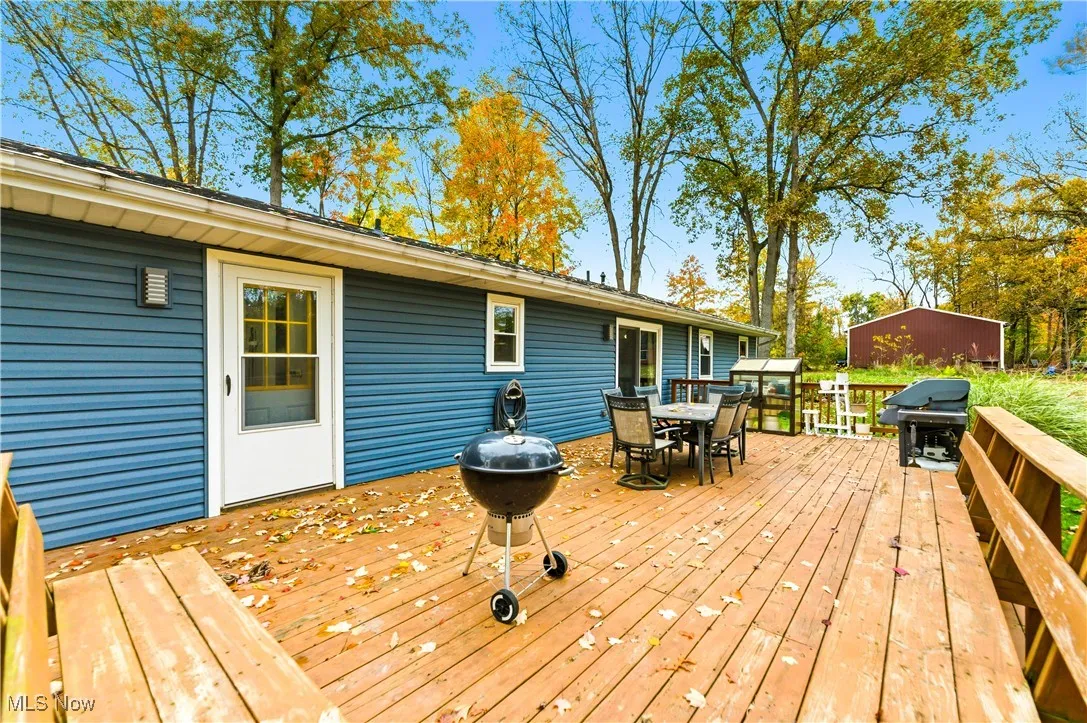 Deck featuring outdoor dining space and grilling area