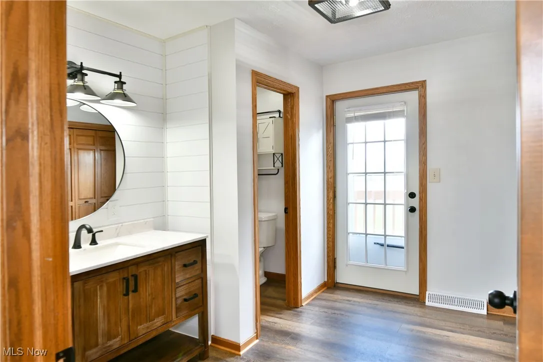 Bathroom with vanity and dark wood-style floors