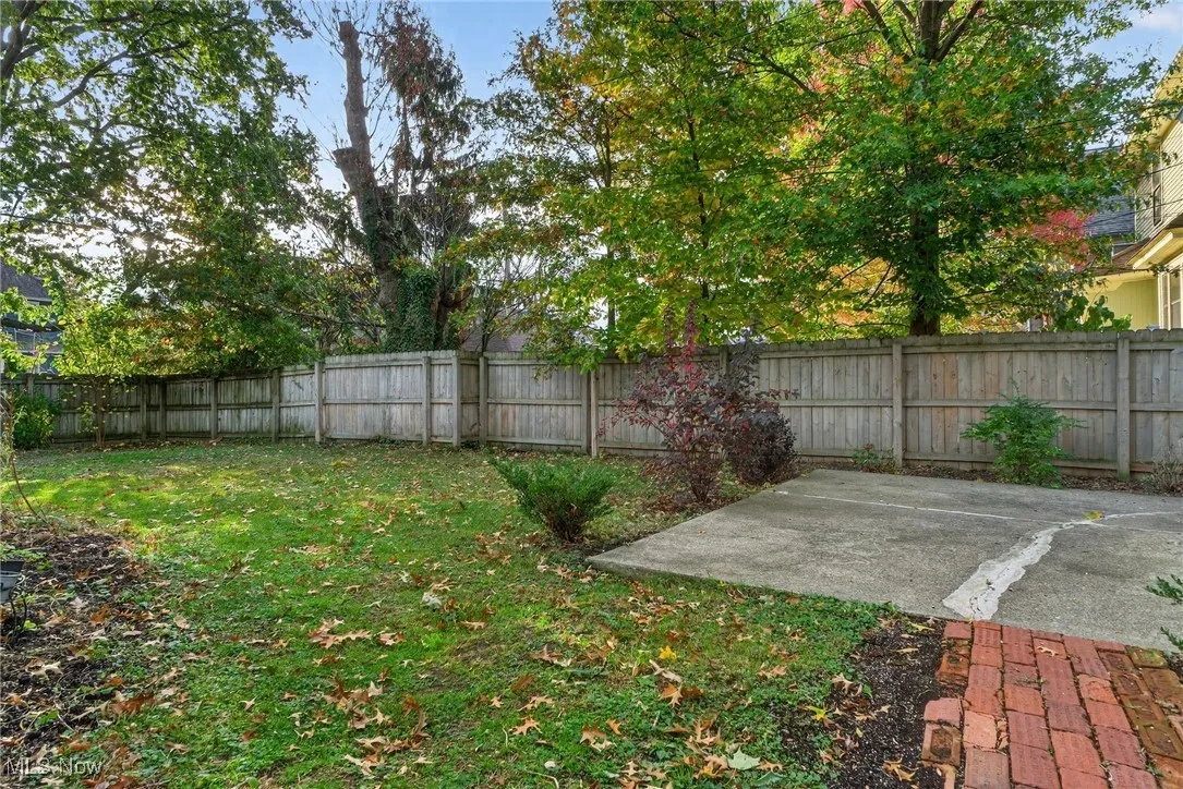 View of lawn, brick pathway and concrete patio