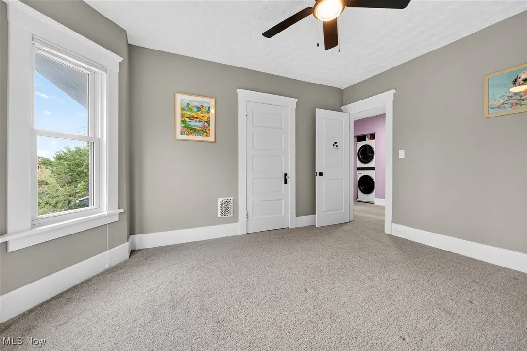 Second floor bedroom looking out to landing and second floor laundry